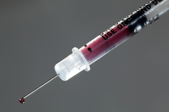 Close up of drop of blood on needle